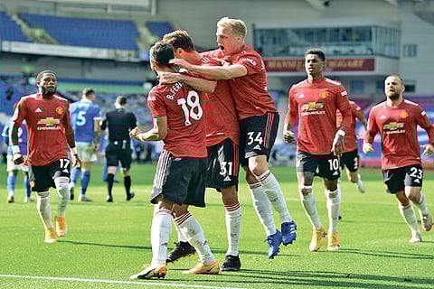 Manchester United players celebrate the winning goal against Brighton