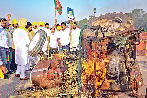 Activists set on fire a tractor near India Gate during protest in New Delhi