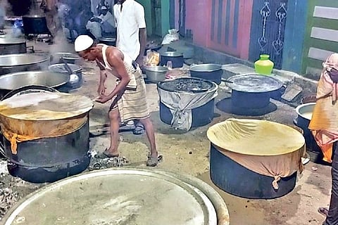 Cooks preparing biryani to be served to party workers.