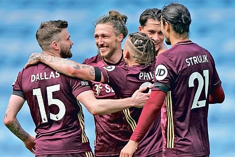Leeds players celebrate the victory over City