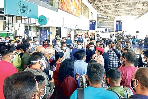 flight was rescheduled for Sunday evening. Passengers crowd in front of check-in counter after fligh
