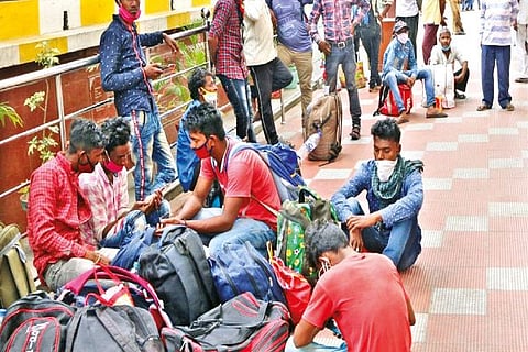 A small group of migrant workers waiting at the Coimbatore railway station
