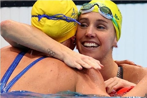 Emma McKeon of Australia and Sarah Sjoestroem of Sweden all smiling after race (Reuters)
