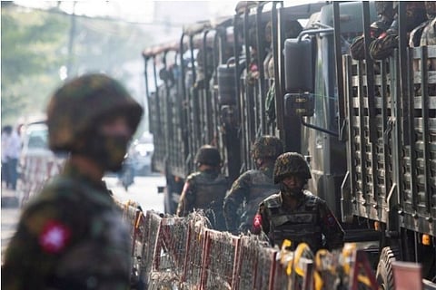 Soldiers are seen standing next to military vehicle (Credit: Reuters)