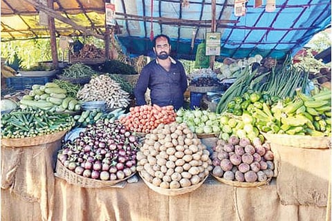 A trader waiting for customers in Gudiyattam on Sunday as he found less takers due to high vegetable