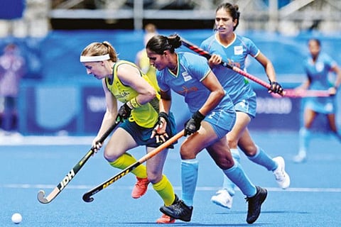 Indian goal-scorer Gurjit Kaur (right) vies for the ball in the last-8 clash against Australia