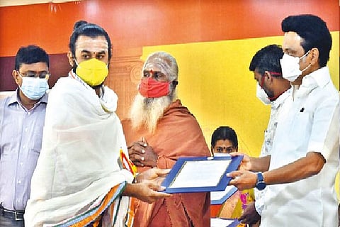 Chief Minister MK Stalin handing over order to one of the archakas on Saturday