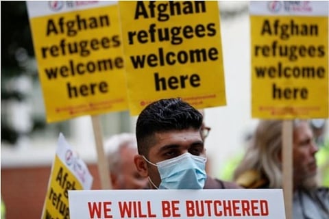 Demonstrators protest to support Afghan refugees (Credit: Reuters)