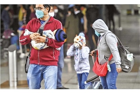 Passengers arrive from Singapore at Delhi airport on Thursday