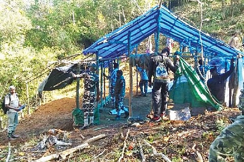 Forest department officials attempting to remove a hut in Anamalai Tiger Reserve on Friday