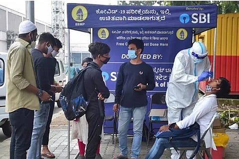A healthcare worker collects sample from a person in Bengaluru (Photo: PTI)