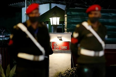 Security personnel stand guard outside Rawat's residence