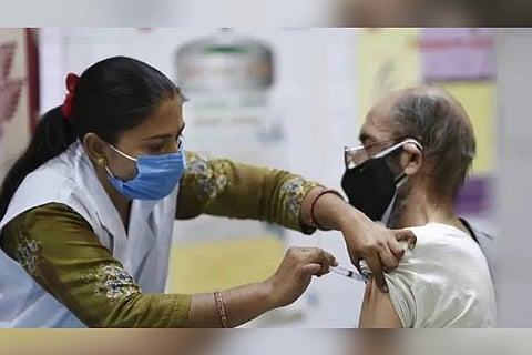 A healthcare worker gives a covid jab (Image credit: PTI)