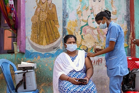 A healthcare worker gives a covid jab (Image credit: PTI)