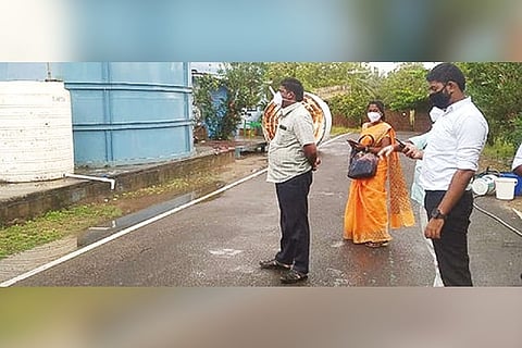 Officials inspecting the fish oil tanks at a private firm near Thondi in Ramanathapuram on Sunday