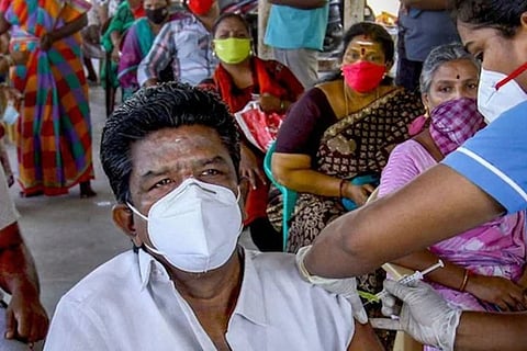 A healthcare worker gives a covid jab (Image credit: PTI)