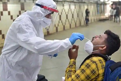 A healtworker is taking RT-PCR test