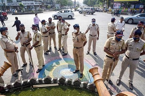 Police personnel guard as activists stage protest after miscreants vandalized Shivaji statue (PTI)