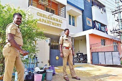 Cops stand outside one of the premises during the raid