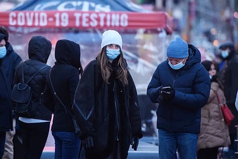 People wait at a street-side testing booth in New York's Times Square on Monday (Image credit: AFP)