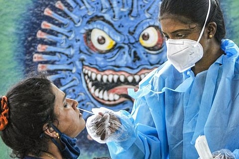 A health worker taking a swab sample (Image credit: PTI)