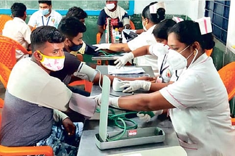 Bull tamers being screened by health workers in Madurai