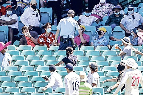 Police talk to spectators after a complaint by the players