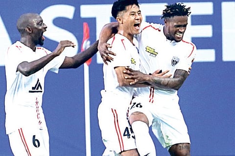 NEUFC striker Deshorn Brown celebrates a goal with his teammates