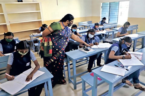 Students maintain social distancing and wear masks in classroom