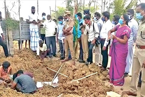 Officials unearthing the skeleton of the boy near Pattukkottai in Thanjavur on Monday