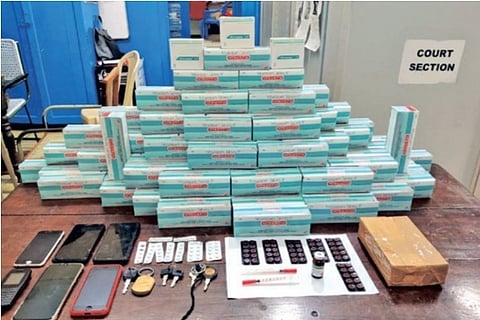 The drugs and cell phones seized from the gang on display in Tiruchy on Tuesday