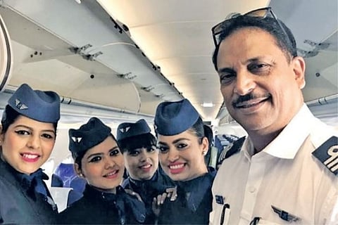 Former Union Minister for Civil Aviation Rajiv Pratap Rudy with crew members aboard Indigo flight 6E