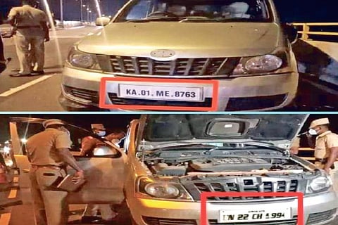 Police inspecting the car with Karnataka registration numbers stuck on Tamil Nadu number plate