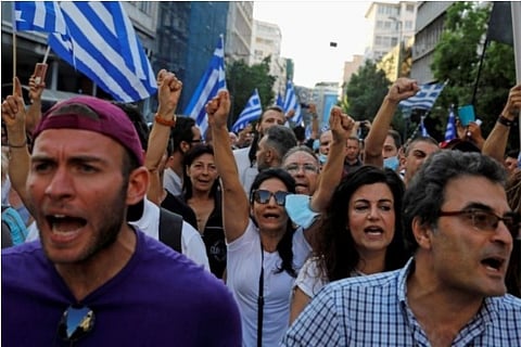 Demonstrators scream slogans against compulsory vaccination (Credit: Reuters)