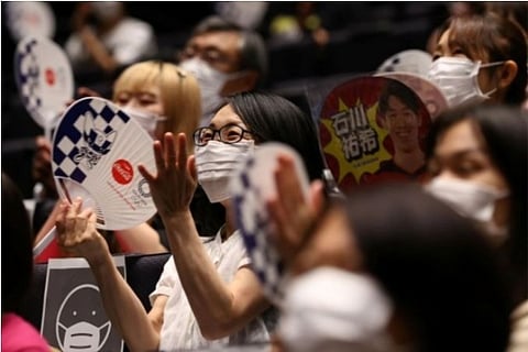 Fans enjoy a live basketball match between Japan and Poland (Source: Reuters)