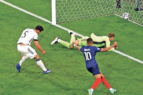 Germany?s Mats Hummels (left) reacts after deflecting the ball into his own net against France