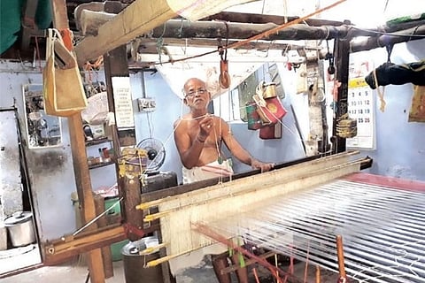 An elderly weaver seen weaving a ?Chediputta? sari at his house in Vellanguli village in Tirunelveli