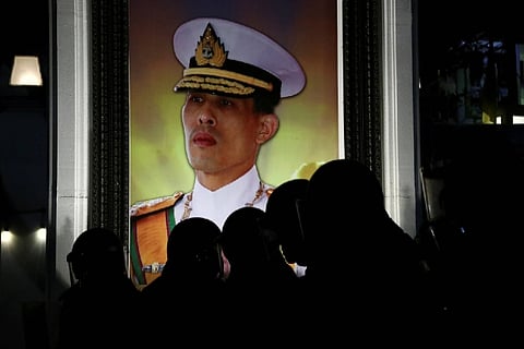 Thai activist accused of burning king's portrait arrested