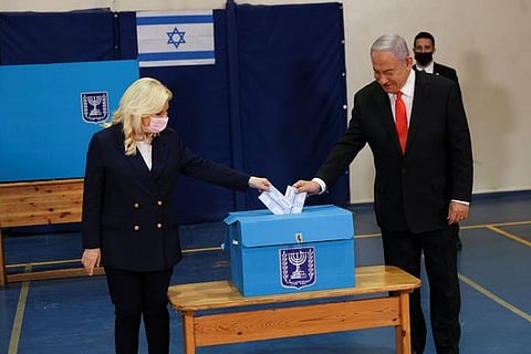 Israel votes as Netanyahu hopes vaccine rollout overcomes corruption trial