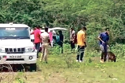 Police inspecting the site of murder with the help of a sniffer dog near the lake bed of Padapai