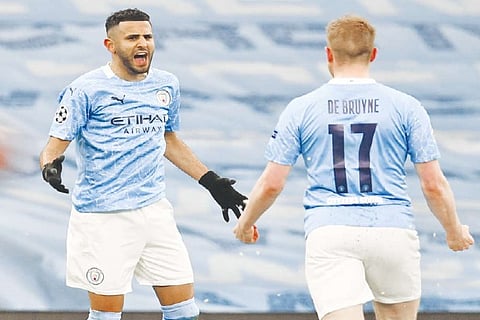 Riyad Mahrez (left) celebrates with Kevin De Bruyne after scoring the opening goal for Man City
