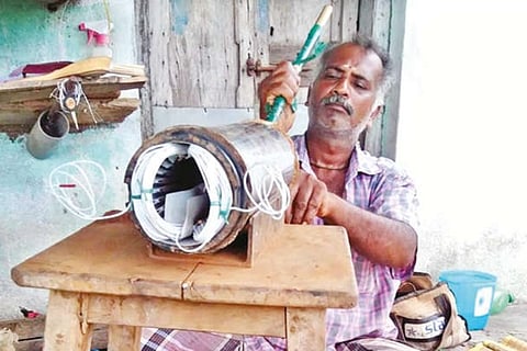 A mechanic repairing a motor of farm pumpset in Nemili, Ranipet dist