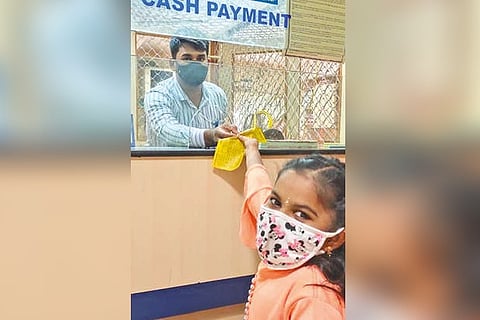 PK Pranaveka gives the draft to bank authorities.