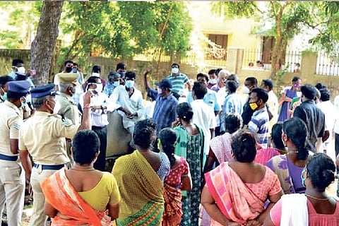 Residents confronting officials who came to resume operations at the crematorium at Thorapadi
