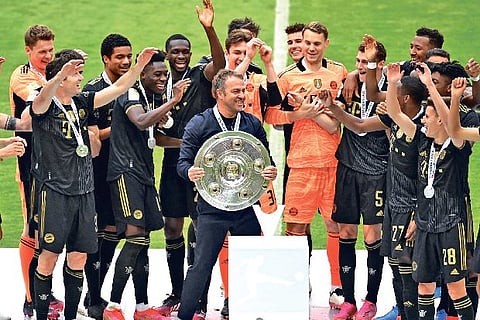 Bayern Munich players and support staff celebrate after lifting the Bundesliga trophy