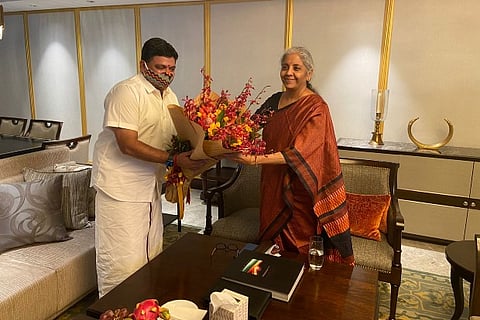 TN Finance Minister Palanivel Thiaga Rajan presenting a bouquet to Union Minister Nirmala Sitharaman