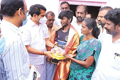 Electricity Minister V Senthilbalaji appreciating the tribal youth Radhakrishnan, who cleared NEET.