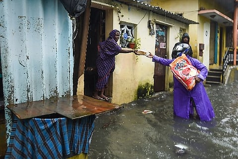 Residents at a waterlogged area of KM Garden following heavy rain, in Chennai