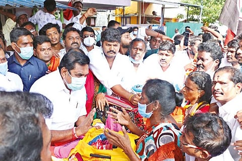 Edappadi K Palaniswami distributing flood relief items to the affected people in Chennai on Friday