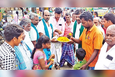 Elated farmers distributing sweets in Ariyalur